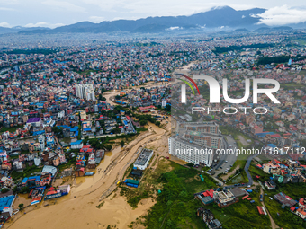 A drone view shows the Nakhu River flooding and affecting the riverbanks and homes during heavy rainfall in Lalitpur, Nepal, on September 28...