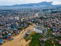 A drone view shows the Nakhu River flooding and affecting the riverbanks and homes during heavy rainfall in Lalitpur, Nepal, on September 28...