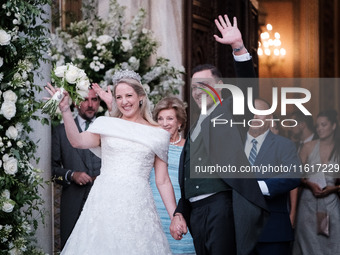 Princess Theodora Glucksburg of Greece and Matthew Jeremiah Kumar greet after their wedding at the Metropolitan Cathedral in Athens, Greece,...