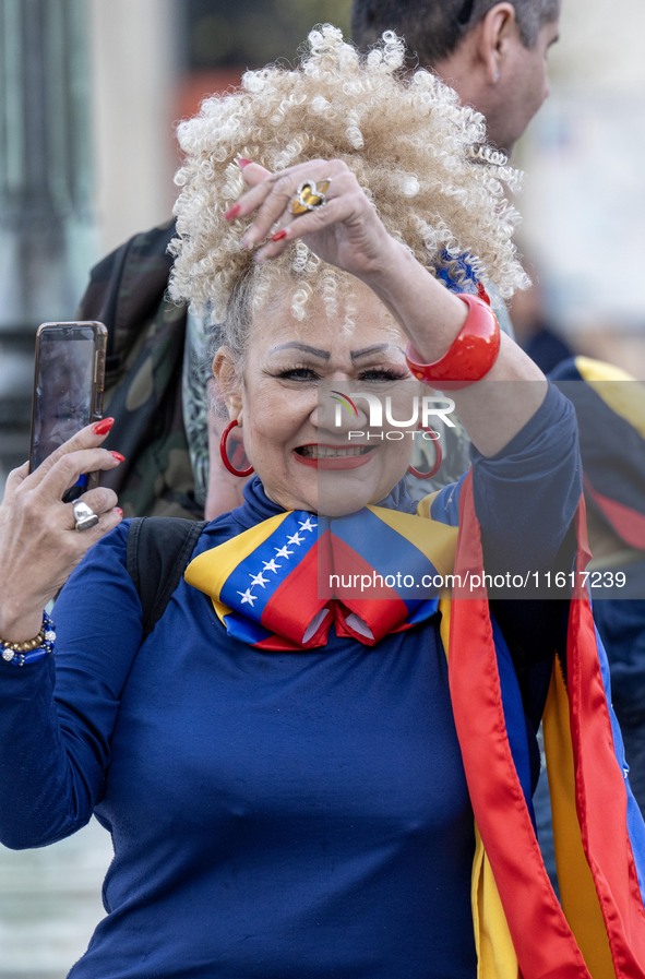 A woman wearing clothes allegorical to the Venezuelan flag gesticulates during a demonstration at Restauradores Square in Lisbon, Portugal,...