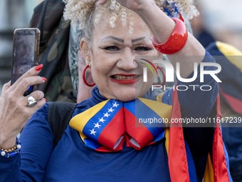 A woman wearing clothes allegorical to the Venezuelan flag gesticulates during a demonstration at Restauradores Square in Lisbon, Portugal,...