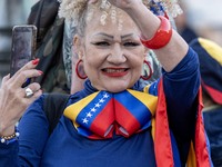 A woman wearing clothes allegorical to the Venezuelan flag gesticulates during a demonstration at Restauradores Square in Lisbon, Portugal,...