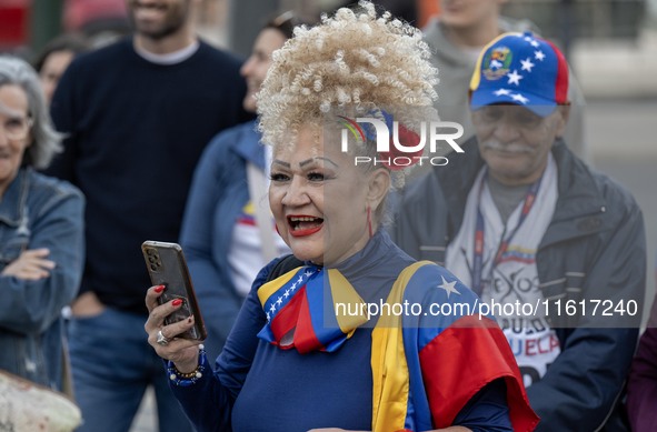 A woman wearing clothes allegorical to the Venezuelan flag gesticulates during a demonstration at Restauradores Square in Lisbon, Portugal,...