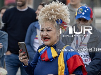 A woman wearing clothes allegorical to the Venezuelan flag gesticulates during a demonstration at Restauradores Square in Lisbon, Portugal,...