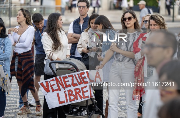 Several people carry a placard with the slogan ''Venezuela libre (Free Venezuela)'' during a demonstration at Restauradores Square in Lisbon...