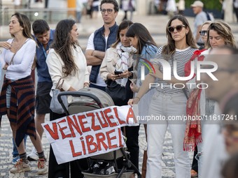 Several people carry a placard with the slogan ''Venezuela libre (Free Venezuela)'' during a demonstration at Restauradores Square in Lisbon...