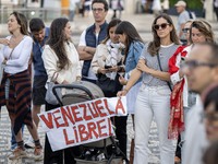 Several people carry a placard with the slogan ''Venezuela libre (Free Venezuela)'' during a demonstration at Restauradores Square in Lisbon...