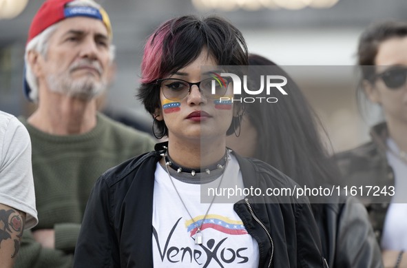 A woman with a Venezuelan flag drawn on her face rallies during a demonstration at Restauradores Square in Lisbon, Portugal, on September 28...