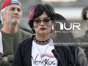 A woman with a Venezuelan flag drawn on her face rallies during a demonstration at Restauradores Square in Lisbon, Portugal, on September 28...