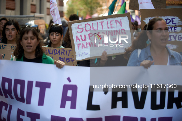 A woman holds a cardboard sign reading 'Support for the 'planning familial''. For International Safe Abortion Day, hundreds of women and men...