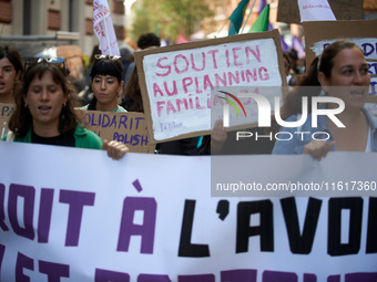 A woman holds a cardboard sign reading 'Support for the 'planning familial''. For International Safe Abortion Day, hundreds of women and men...