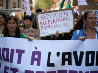 A woman holds a cardboard sign reading 'Support for the 'planning familial''. For International Safe Abortion Day, hundreds of women and men...