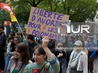 A woman holds a cardboard sign reading 'Abortion for Polish women'. For International Safe Abortion Day, hundreds of women and men take to t...