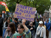 A woman holds a cardboard sign reading 'Abortion for Polish women'. For International Safe Abortion Day, hundreds of women and men take to t...