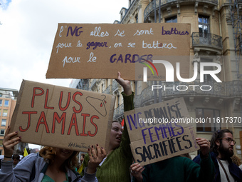 Women hold placards reading (left to right) 'Never again' and 'Right to abortion, they fought to win it, we'll fight for keeping it'. For In...