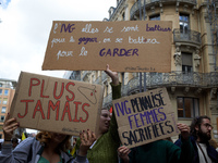 Women hold placards reading (left to right) 'Never again' and 'Right to abortion, they fought to win it, we'll fight for keeping it'. For In...