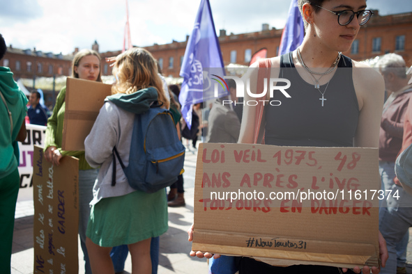 A young woman holds a cardboard sign reading '1975 Veil law, 48 years after, abortion is still in danger'. In Toulouse, France, on September...