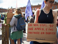 A young woman holds a cardboard sign reading '1975 Veil law, 48 years after, abortion is still in danger'. In Toulouse, France, on September...