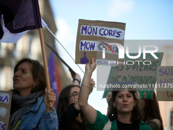 A woman holds a cardboard sign reading 'my body, my choice'. For International Safe Abortion Day, hundreds of women and men take to the stre...