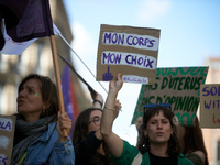 A woman holds a cardboard sign reading 'my body, my choice'. For International Safe Abortion Day, hundreds of women and men take to the stre...