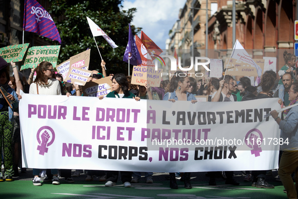 The banner reads 'For the right to abort, here and there, our bodies, our rights'. For International Safe Abortion Day, hundreds of women an...