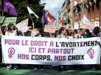 The banner reads 'For the right to abort, here and there, our bodies, our rights'. For International Safe Abortion Day, hundreds of women an...