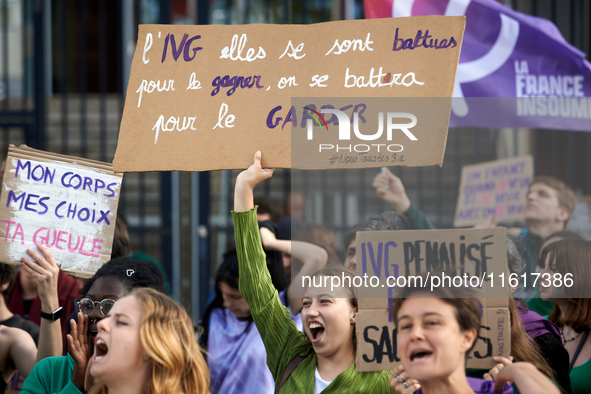 A young woman holds a placard reading 'Abortion they fought for it, we'll fight to keep it'. For International Safe Abortion Day, hundreds o...