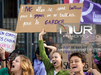 A young woman holds a placard reading 'Abortion they fought for it, we'll fight to keep it'. For International Safe Abortion Day, hundreds o...