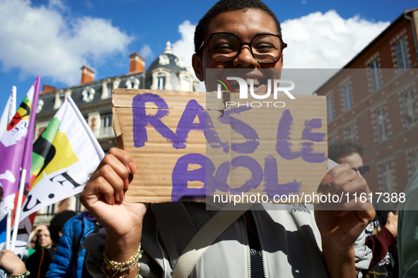 A woman holds a placard reading 'Fed up'. For International Safe Abortion Day, hundreds of women and men take to the streets in Toulouse, Fr...