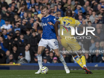 Jarrad Branthwaite #32 of Everton F.C. is tackled by Jean-Philippe Mateta #14 of Crystal Palace F.C. during the Premier League match between...