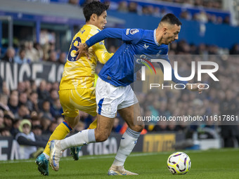 Dwight McNeil #7 of Everton F.C. is tackled by Daichi Kamada #18 of Crystal Palace F.C. during the Premier League match between Everton and...