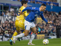 Dwight McNeil #7 of Everton F.C. is tackled by Daichi Kamada #18 of Crystal Palace F.C. during the Premier League match between Everton and...