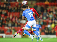 #19, Kyle Wootton of Stockport, and #6, Mael de Gevigney of Barnsley, battle to head the ball during the Sky Bet League 1 match between Barn...