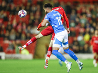 #19, Kyle Wootton of Stockport, and #6, Mael de Gevigney of Barnsley, battle to head the ball during the Sky Bet League 1 match between Barn...