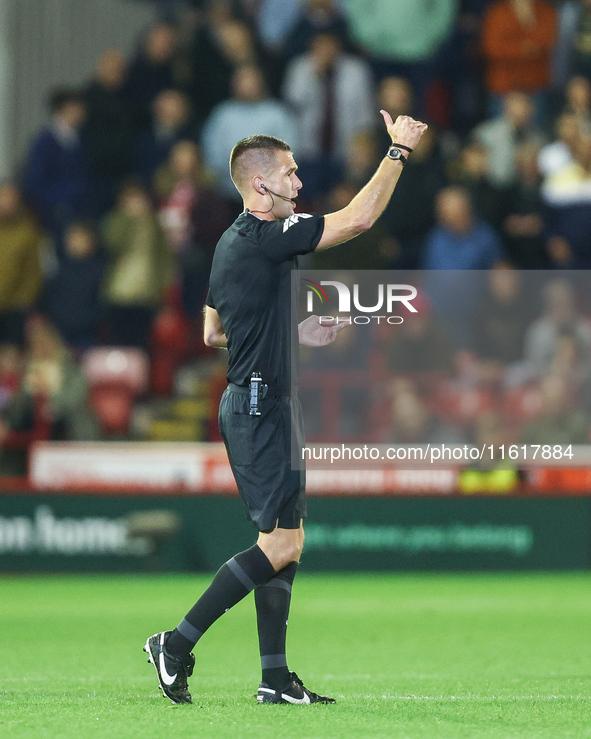 Referee Declan Bourne gives the thumbs up to his assistant during the Sky Bet League 1 match between Barnsley and Stockport County at Oakwel...