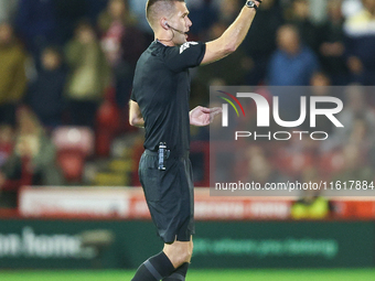 Referee Declan Bourne gives the thumbs up to his assistant during the Sky Bet League 1 match between Barnsley and Stockport County at Oakwel...