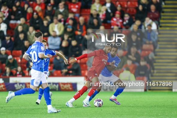 #2, Barry Cotter of Barnsley, tries to get past #3, Ibou Touray of Stockport during the Sky Bet League 1 match between Barnsley and Stockpor...