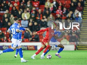 #2, Barry Cotter of Barnsley, tries to get past #3, Ibou Touray of Stockport during the Sky Bet League 1 match between Barnsley and Stockpor...