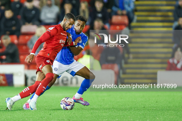 #2, Barry Cotter of Barnsley, tries to get past #3, Ibou Touray of Stockport during the Sky Bet League 1 match between Barnsley and Stockpor...