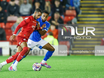 #2, Barry Cotter of Barnsley, tries to get past #3, Ibou Touray of Stockport during the Sky Bet League 1 match between Barnsley and Stockpor...