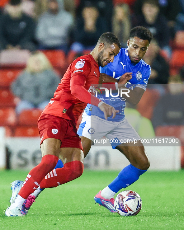 #2, Barry Cotter of Barnsley, tries to get past #3, Ibou Touray of Stockport during the Sky Bet League 1 match between Barnsley and Stockpor...