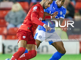 #2, Barry Cotter of Barnsley, tries to get past #3, Ibou Touray of Stockport during the Sky Bet League 1 match between Barnsley and Stockpor...