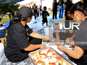 Participants prepare fruit as they set up for a protest at an international students' encampment in Brampton, Canada, on September 28, 2024....