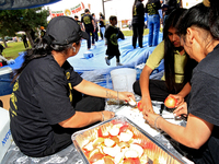 Participants prepare fruit as they set up for a protest at an international students' encampment in Brampton, Canada, on September 28, 2024....