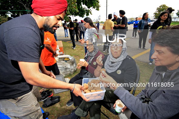 Participants are offered a blended nut snack prior to the start of a protest at an international students' encampment in Brampton, Canada, o...