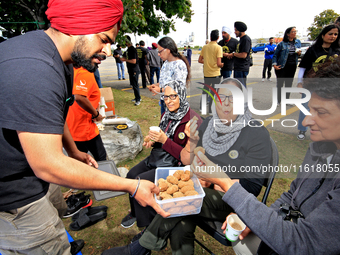 Participants are offered a blended nut snack prior to the start of a protest at an international students' encampment in Brampton, Canada, o...