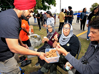 Participants are offered a blended nut snack prior to the start of a protest at an international students' encampment in Brampton, Canada, o...