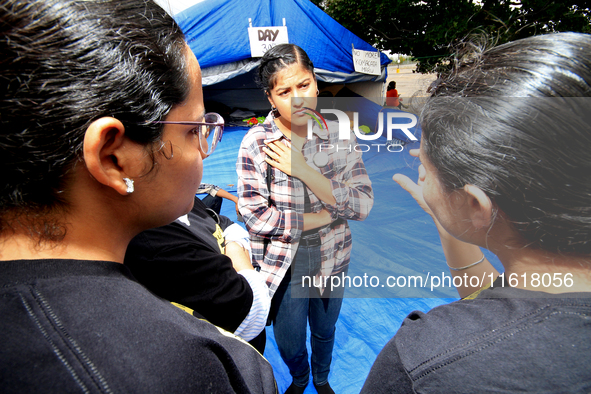 Organizer Simran Kaur listens to students during a protest rally at an international students' encampment in Brampton, Canada, on September...