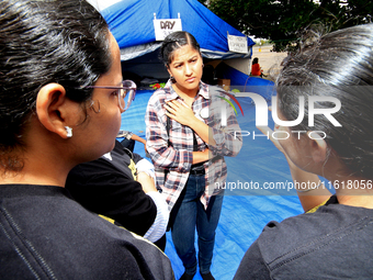 Organizer Simran Kaur listens to students during a protest rally at an international students' encampment in Brampton, Canada, on September...