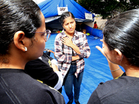 Organizer Simran Kaur listens to students during a protest rally at an international students' encampment in Brampton, Canada, on September...